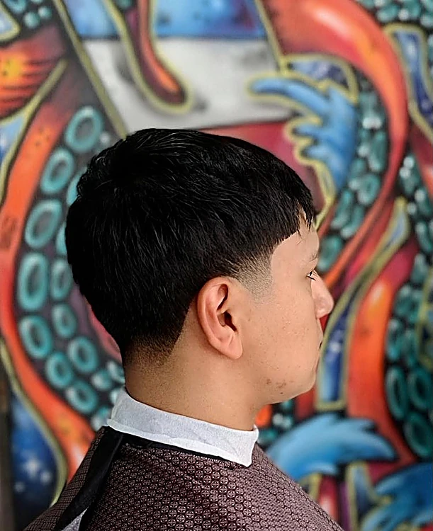 Taper visto de perfil frente a los tentáculos del mural